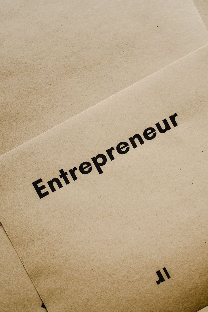 Services Close-up of the word 'Entrepreneur' printed on brown paper, symbolizing business innovation.